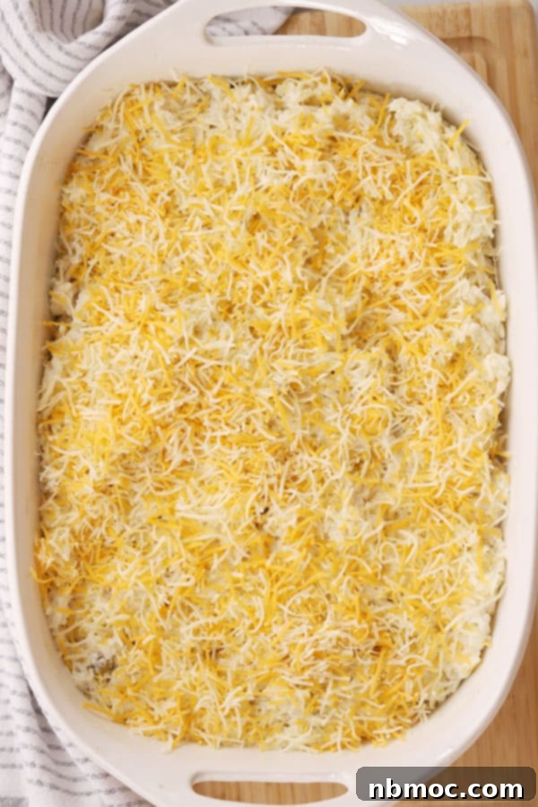 Creamy Green Chile Rice Bake 2 Cheesy green chili rice casserole in a baking dish about to go into the oven.