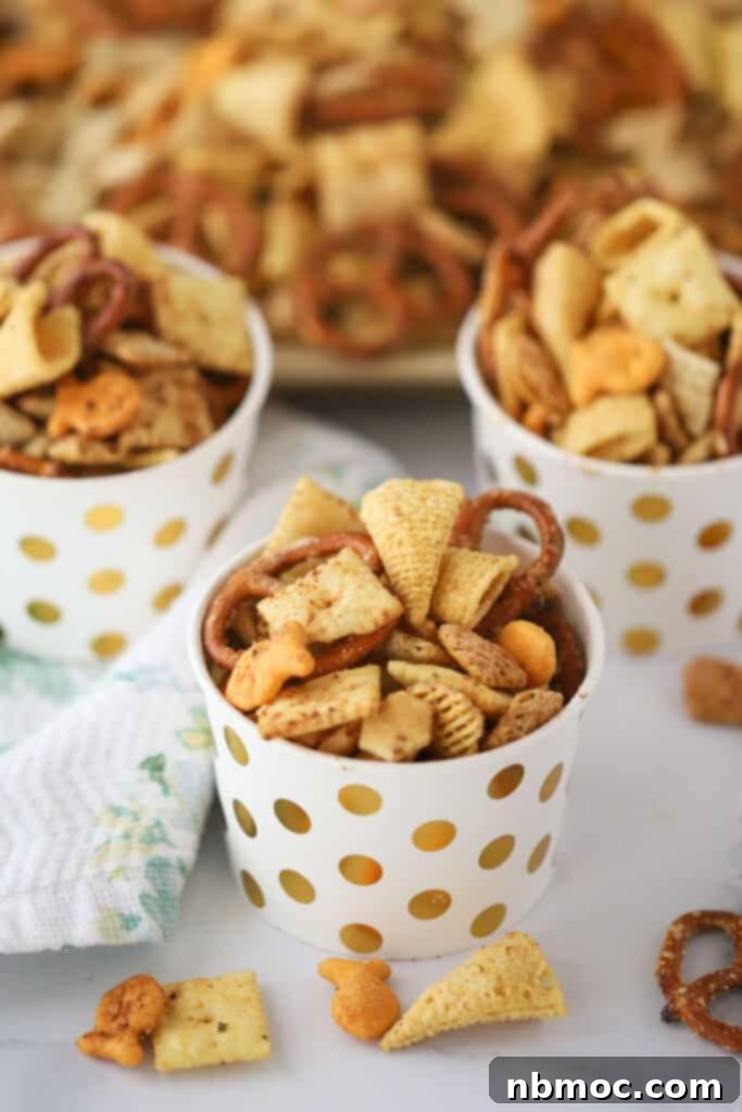 Little decorative cups filled with this ranch chex mix appetizer.