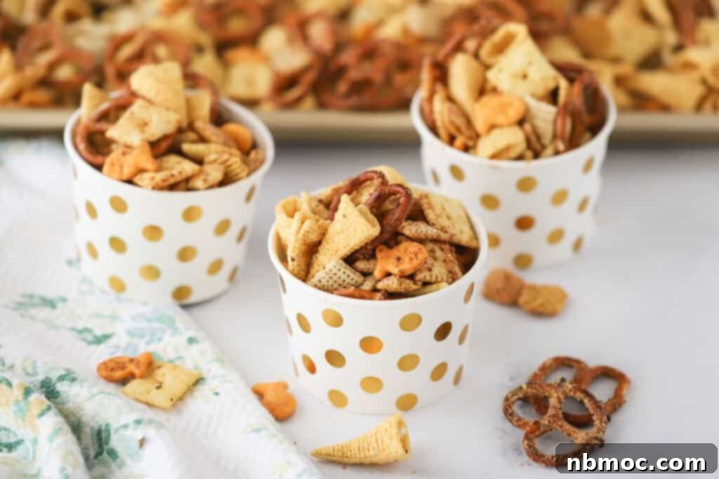 Small cups filled with chex mix (ranch flavored) including pretzels, rice chex, and bugles crackers.
