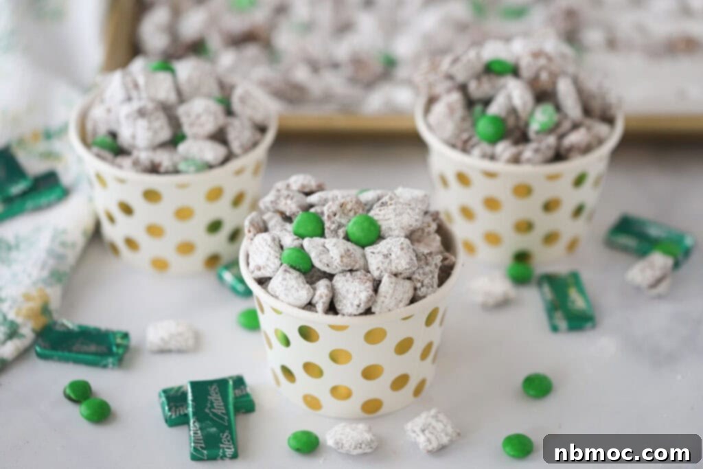 Crisp Mint Chocolate Snack Mix 5 Individual cups full of mint puppy chow surrounded by unwrapped Andes Chocolate Mints.