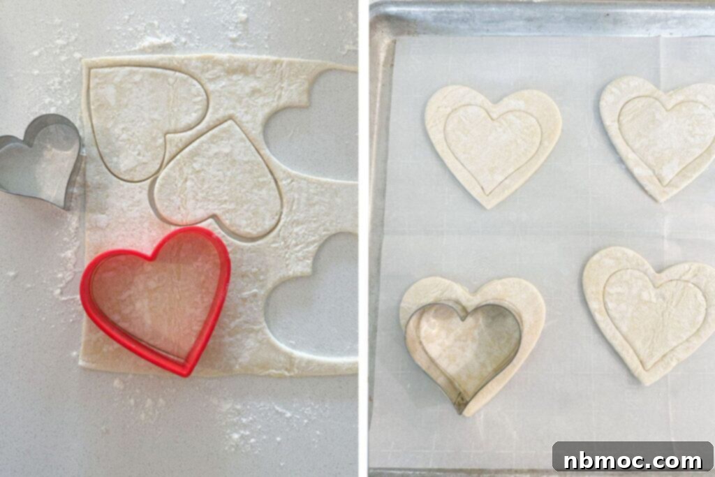 Puff pastry dough on a baking sheet being cut into heart shapes and then scored with a slightly smaller heart cookie cutter, showcasing the easy preparation for homemade Raspberry Danish.