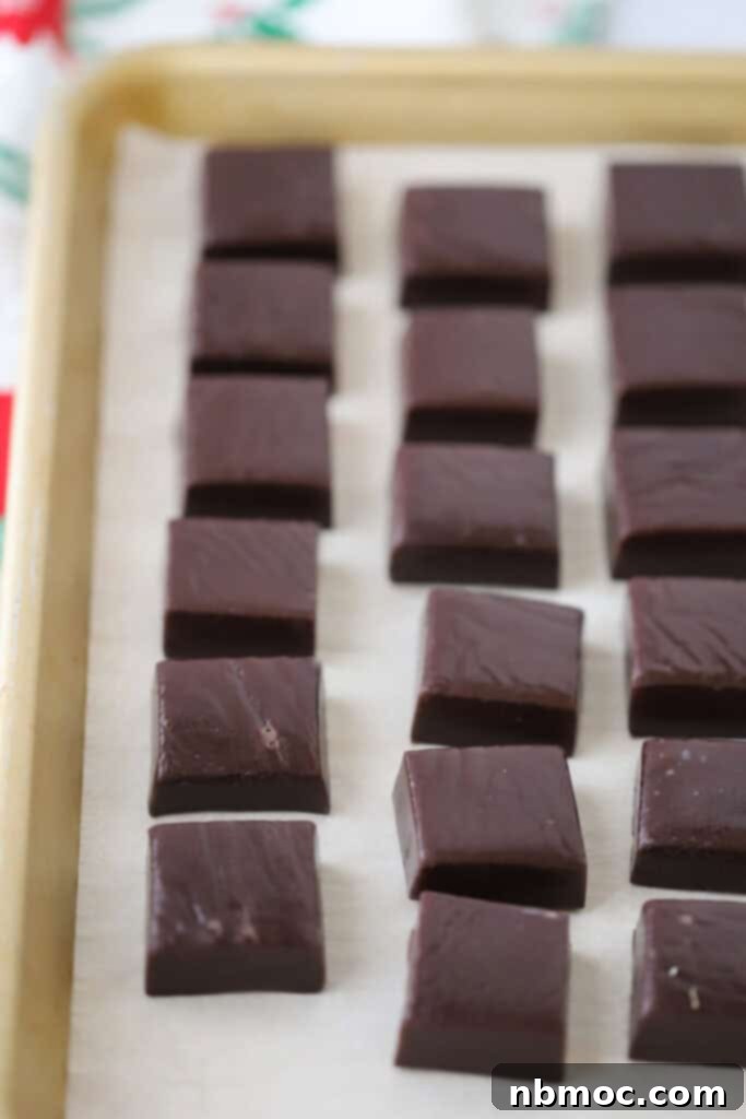 Midnight Licorice Caramels 5 A tray full of cut black licorice caramels.