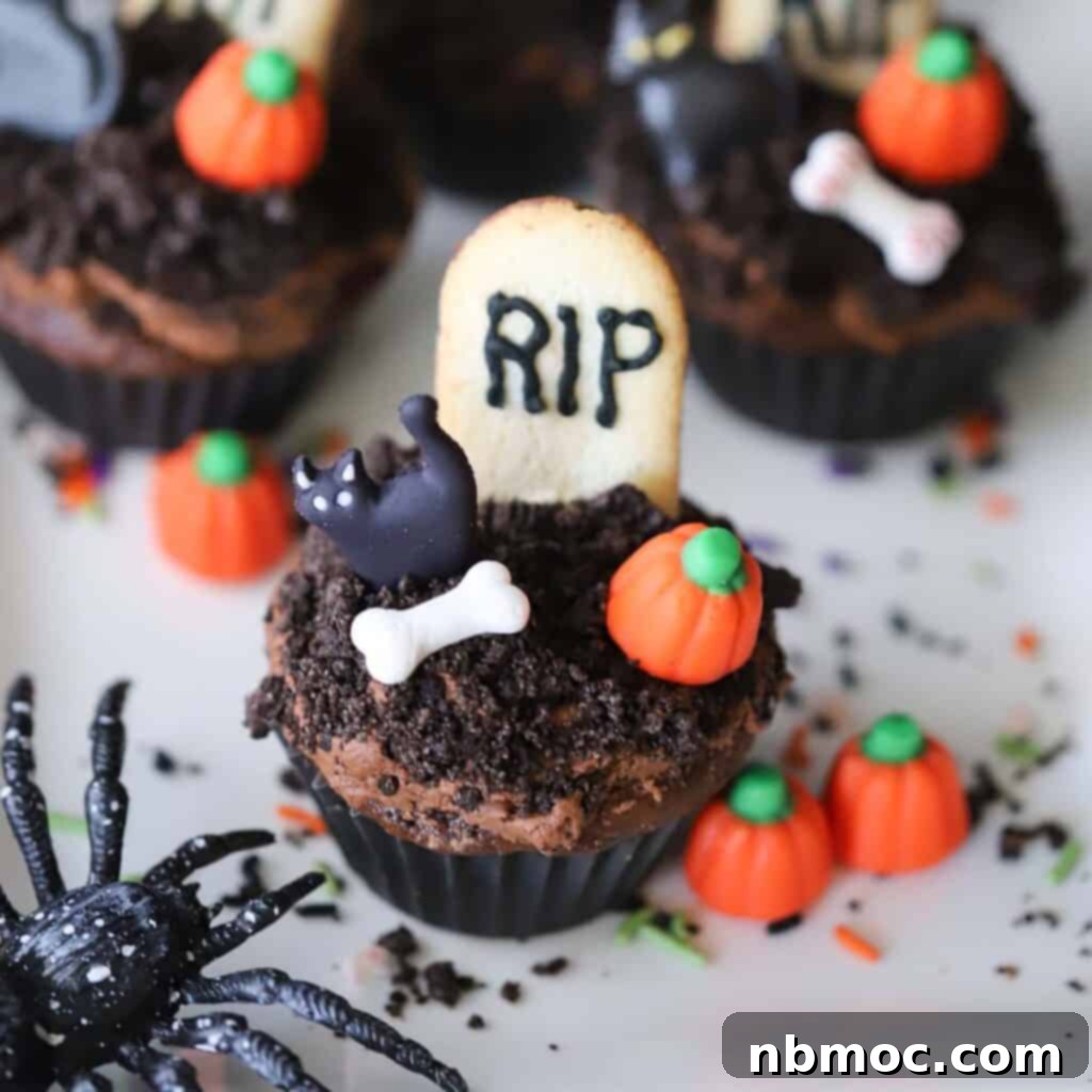 A spooky yet adorable display of graveyard cupcakes, intricately decorated with miniature candy pumpkins and edible bones, perfect for Halloween.