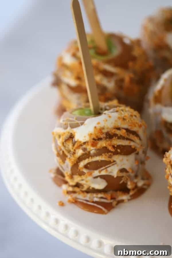 A delightful arrangement of homemade caramel apples displayed on a serving plate, each glistening with rich, sweet caramel.