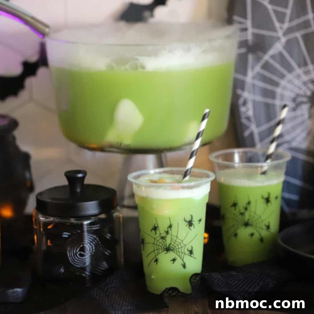 A bubbling bowl of Green Witch Punch, captivatingly set on a Halloween-decorated table, creating an enchanting and spooky ambiance.