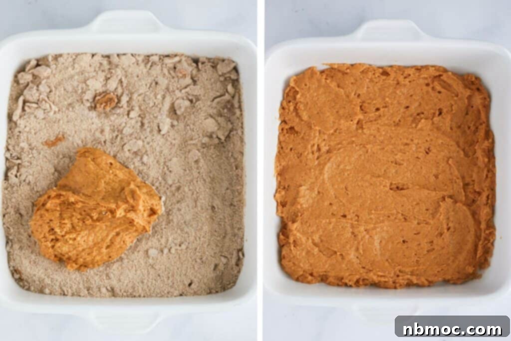 Pumpkin coffee cake in a baking dish with a layer of cinnamon swirl added.