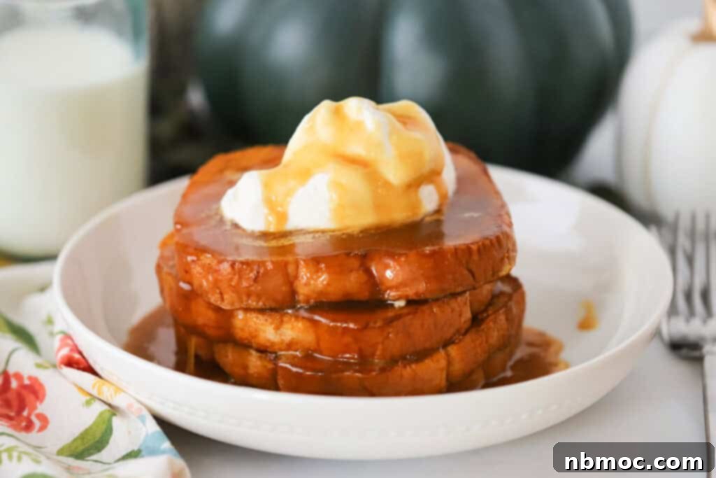 Pumpkin Spice French Toast 5 A large white serving bowl filled to the brim with freshly cooked Pumpkin French Toast, artfully topped with fluffy whipped cream and a glistening homemade syrup.