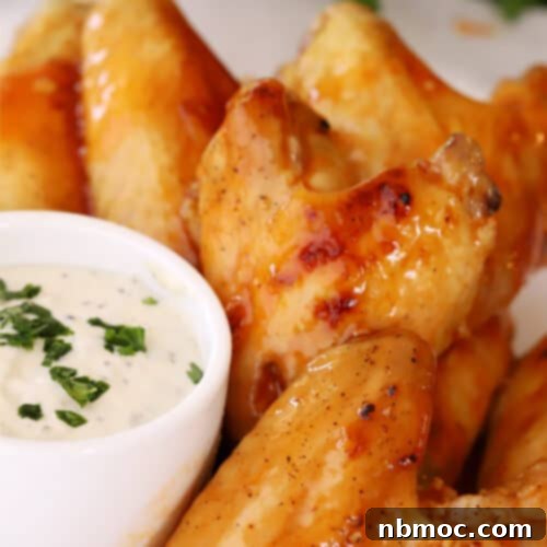 Simple Oven Buffalo Wings 5 Buffalo chicken wings with a side bowl of ranch, how to bake chicken wings oven recipe.