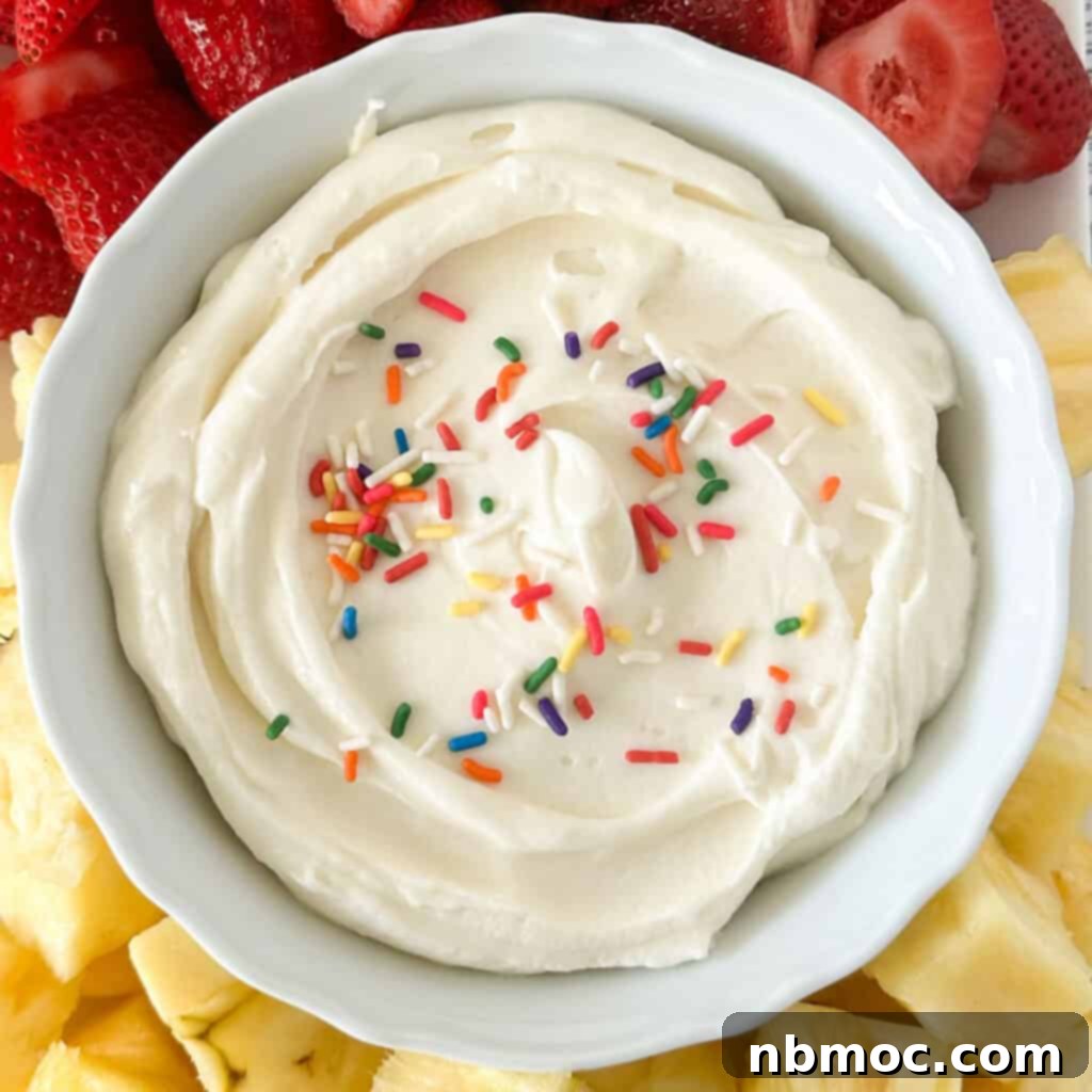 Lemon cheesecake dip in a bowl with colorful sprinkles.