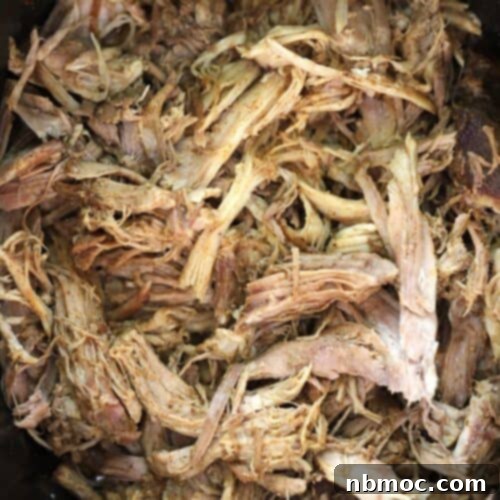 pork recipes for dinner, shredded pork in a slow cooker. A serving of shredded pork on a bun with coleslaw.