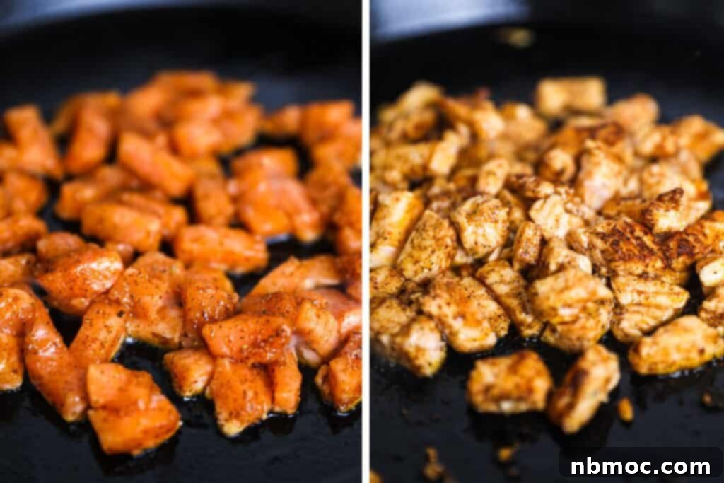 A cast iron skillet with small pieces of salmon cooking for salmon tacos.