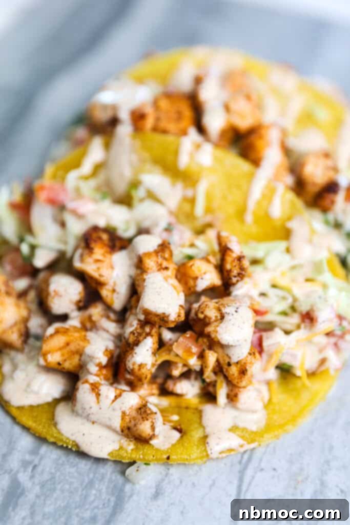 A blackened salmon taco opened to show all of the ingredients.