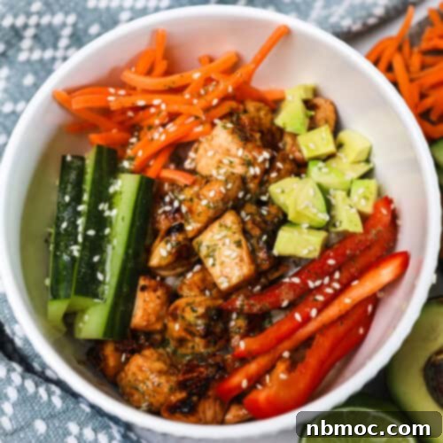 honey citrus salmon bowls recipe, salmon with sliced fresh veggies on rice.