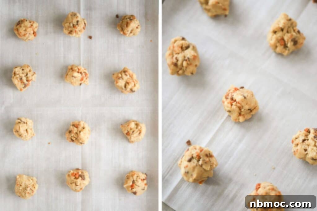 Butterfinger cookie dough balls on a parchment paper lined baking sheet ready to bake.
