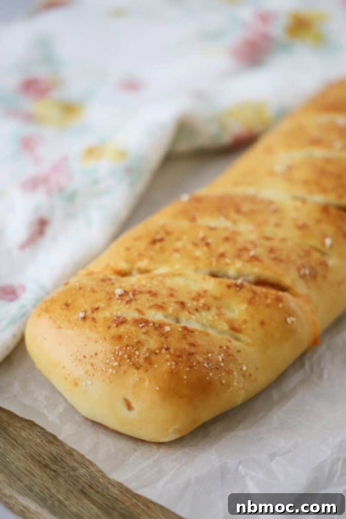 A loaf of this homemade stromboli recipe with slits across the top.