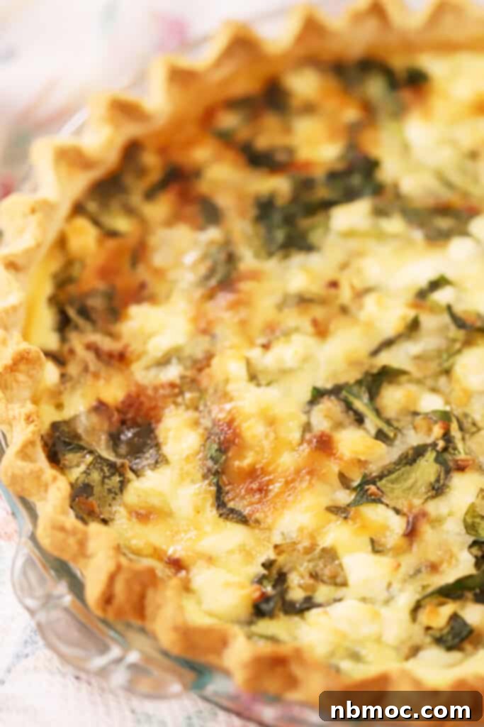 Mediterranean Spinach Feta Quiche 4 a spinach feta cheese quiche with crimped edges.