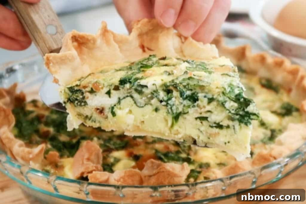 Mediterranean Spinach Feta Quiche 6 a slice of spinach quiche on a spatula.