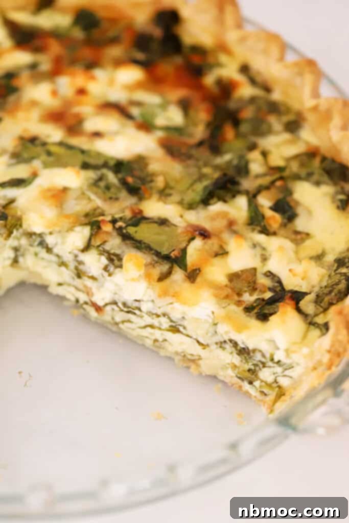 Mediterranean Spinach Feta Quiche 7 a slice of spinach quiche missing from the pie plate.