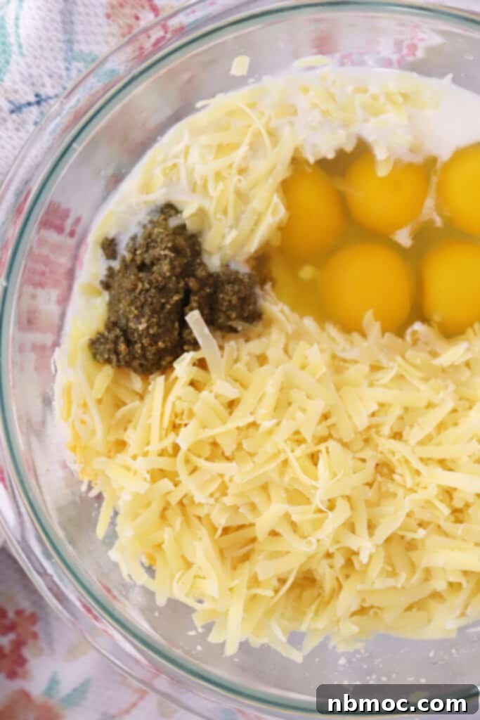 Triple Cheese Pesto Quiche 3 easy cheese and pesto quiche ingredients in a bowl.