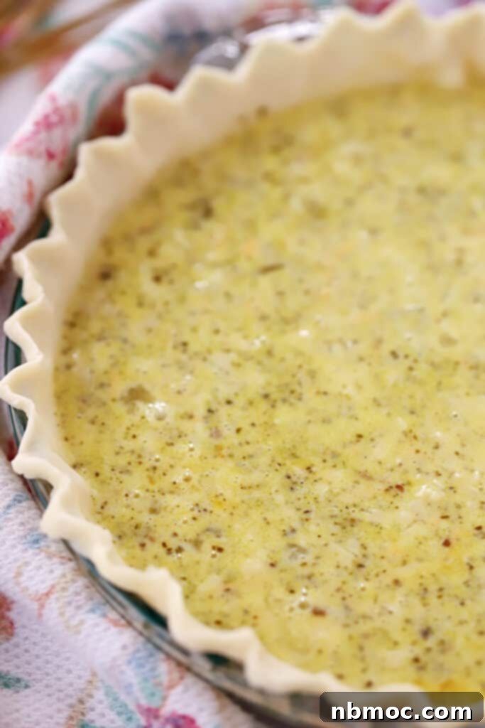 Triple Cheese Pesto Quiche 4 unbaked pesto quiche in a pie crust, ready to be baked, cheese in pesto. types of quiche. best quiche pesto recipe.