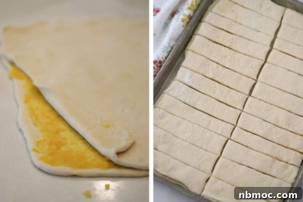 Adding the orange filling to the center of these breadsticks.