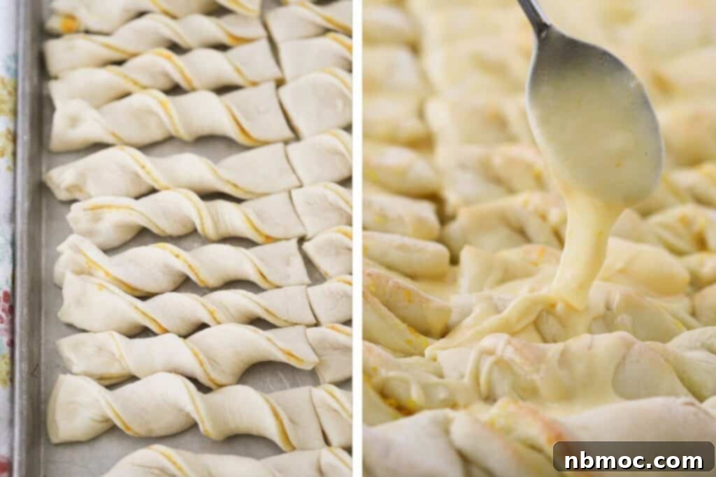 A spoon drizzling orange glaze over the tops. of baked breadsticks.