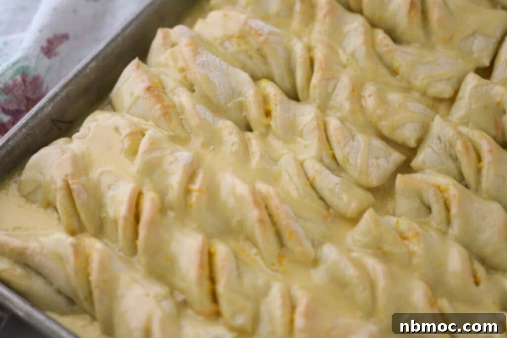 Orange roll breadsticks in a baking pan.