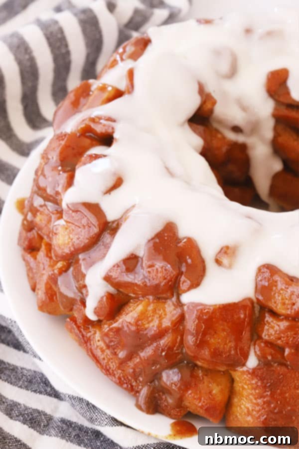Quick and Easy Monkey Bread 4 Close-up of baked monkey bread topped with a sweet white icing, ready to be enjoyed.