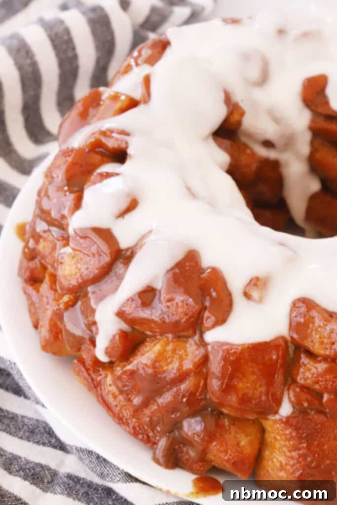 Gooey Cinnamon Pull-Apart Bread 2 A plate with cinnamon roll monkey bread topped with icing.