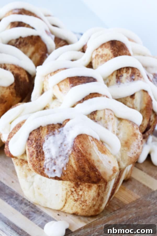 Cinnamon Twist Bread with generous drizzles of homemade vanilla icing, ready to be served.