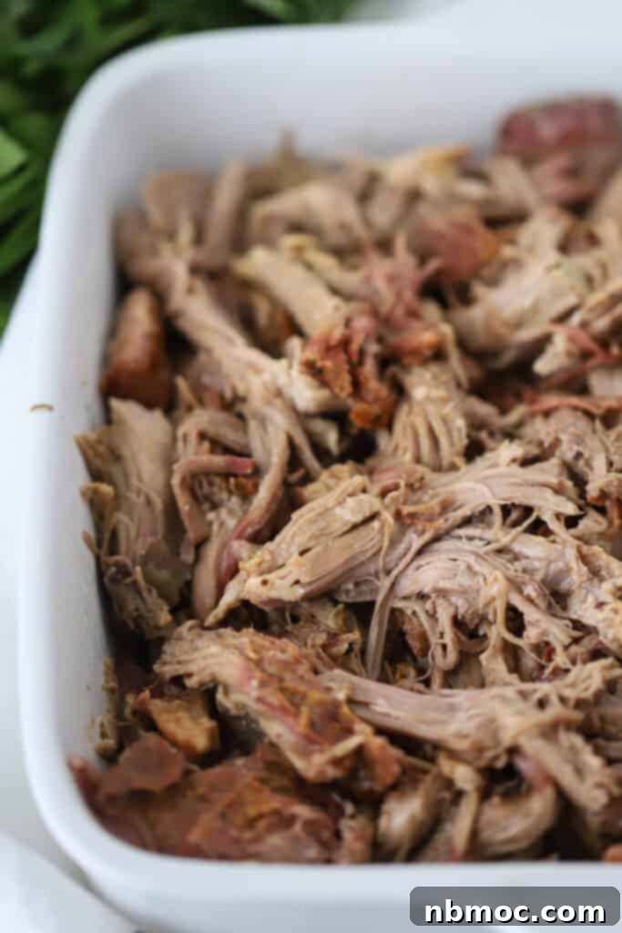 Smoked pulled pork in a white baking dish.