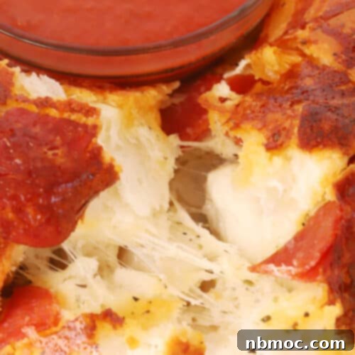 Close-up of golden brown Pizza Monkey Bread fresh from the oven, showcasing its delicious texture and melted cheese.