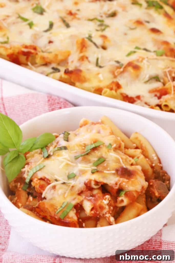 Quick and Comforting Baked Ziti 2 A bowl full of this baked ziti recipe with beef, pasta sauce, and three kinds of cheese.