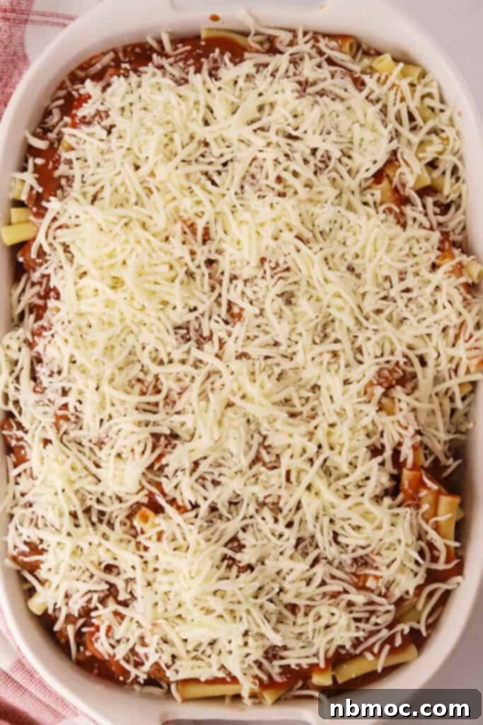 Quick and Comforting Baked Ziti 3 A baking dish layered with pasta, red sauce, and shredded cheese.