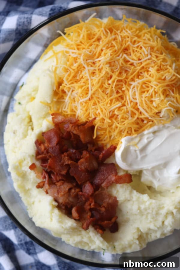 ingredients for easy twice baked potato casserole in a large glass mixing bowl.