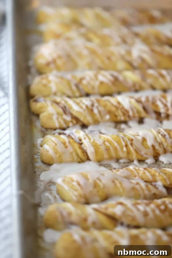 Freshly baked Einkorn Cinnamon Breadsticks on a baking dish, ready to be glazed. Best Einkorn recipes for a sweet treat.
