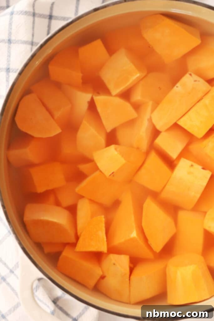 sweet potatoes cooking in a pot with water.