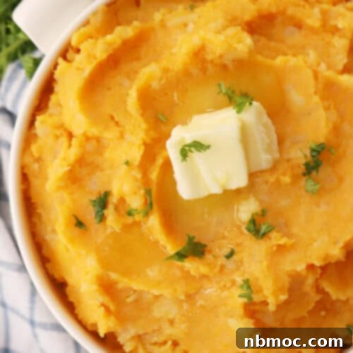 Velvety Root Puree 7 mashed root vegetables in a white bowl with a pat of butter