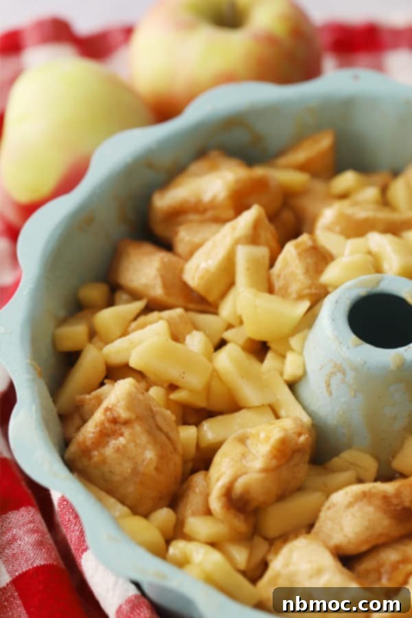 Warm Spiced Apple Monkey Bread 5 Unbaked Monkey Bread with apples visible in a bundt pan, ready to go into the oven.