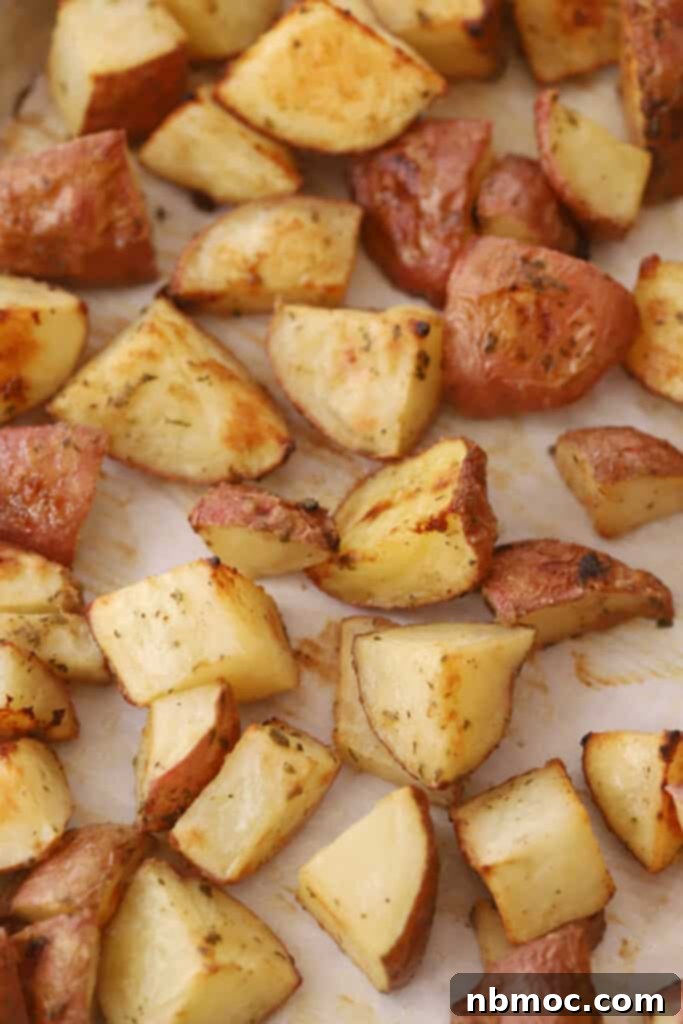 Golden Roasted Red Skinned Potatoes 6 A sheet tray with quartered and roasted red skin potatoes.